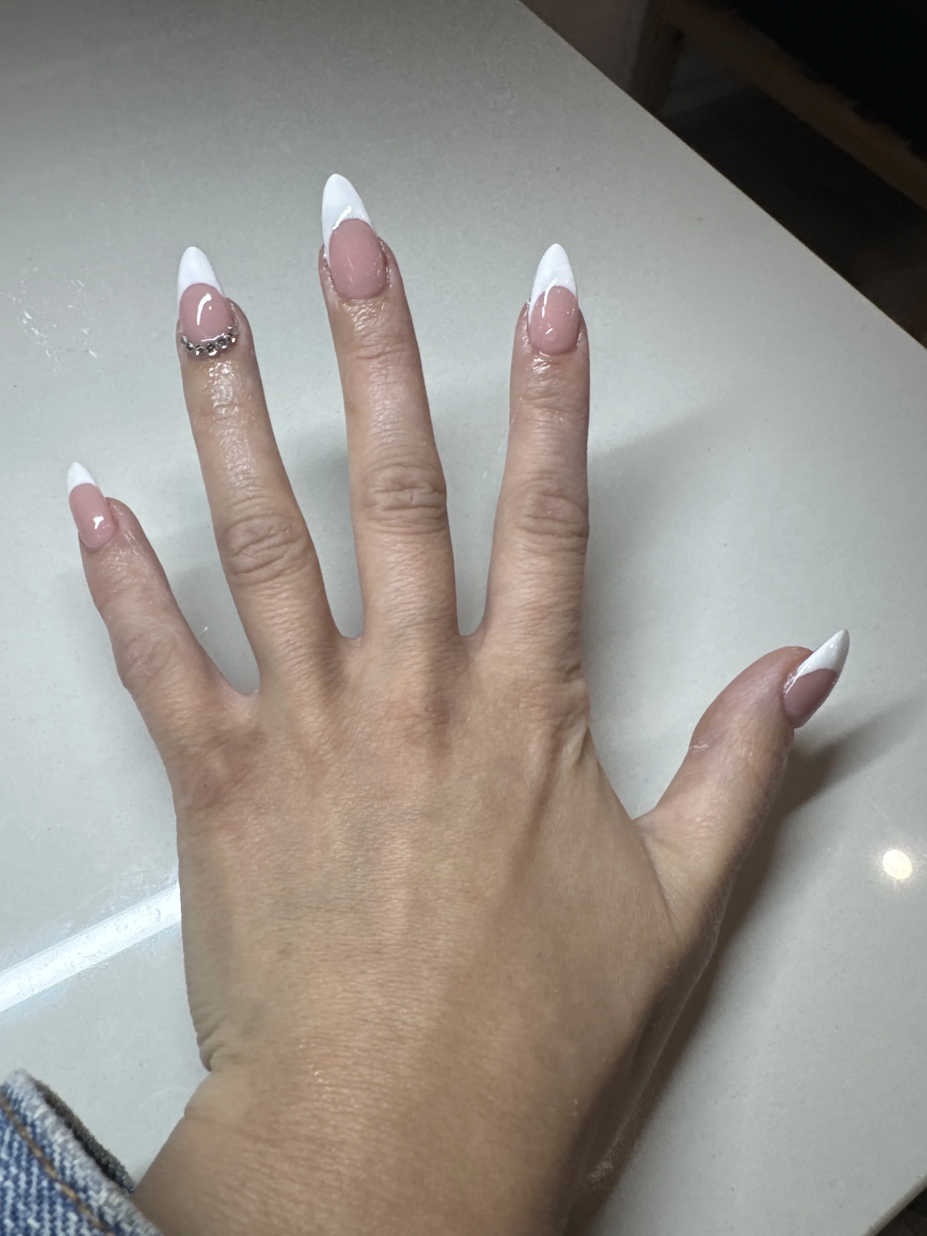 White French almond tips with rhinestone accent — Minack Beauty nail work
