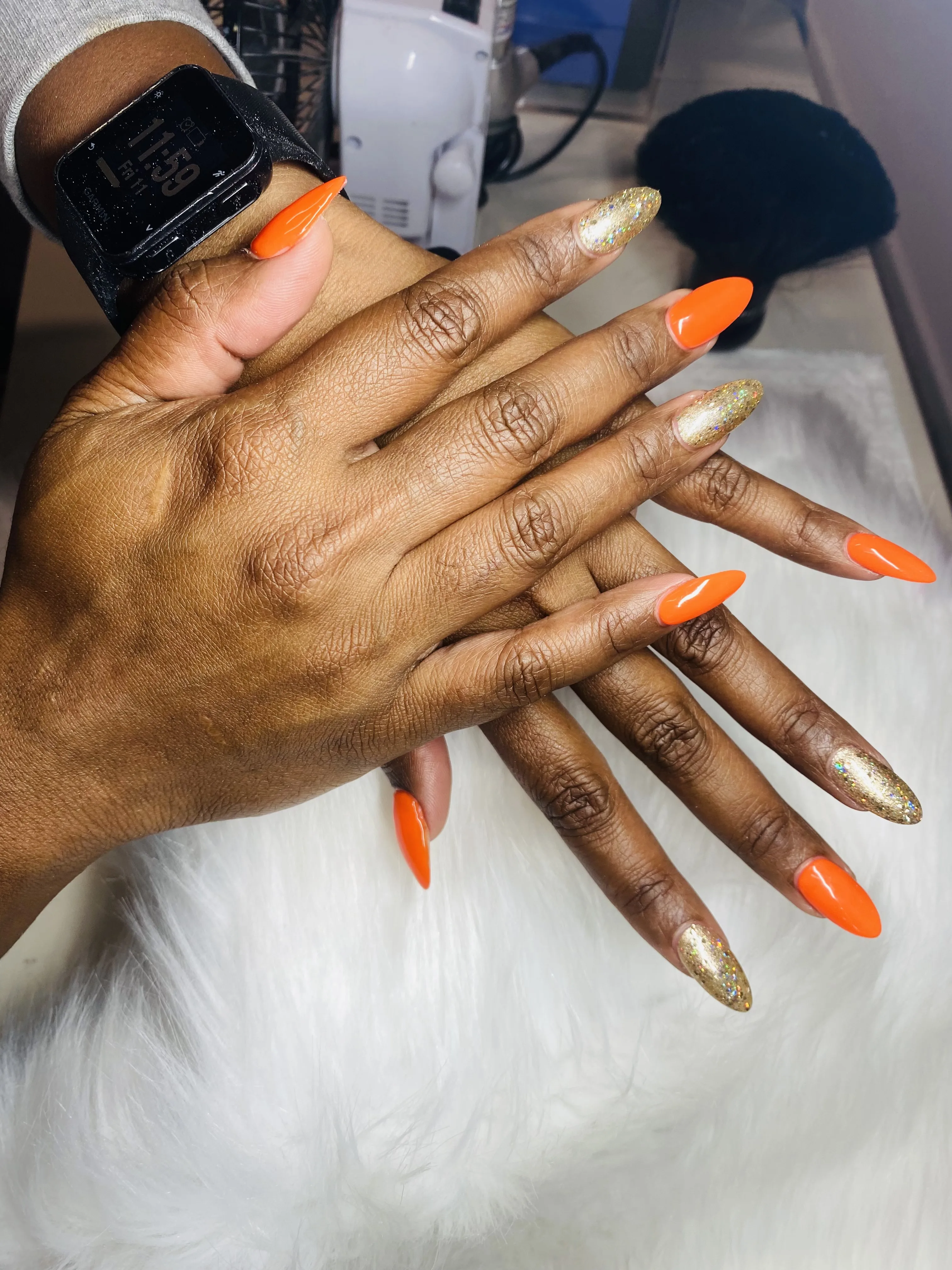 Neon-orange and gold-glitter stiletto nails — Minack Beauty nail work
