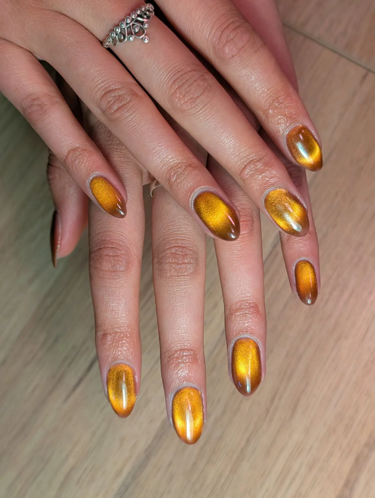 Amber gold cat-eye chrome almond nails — Minack Beauty nail work