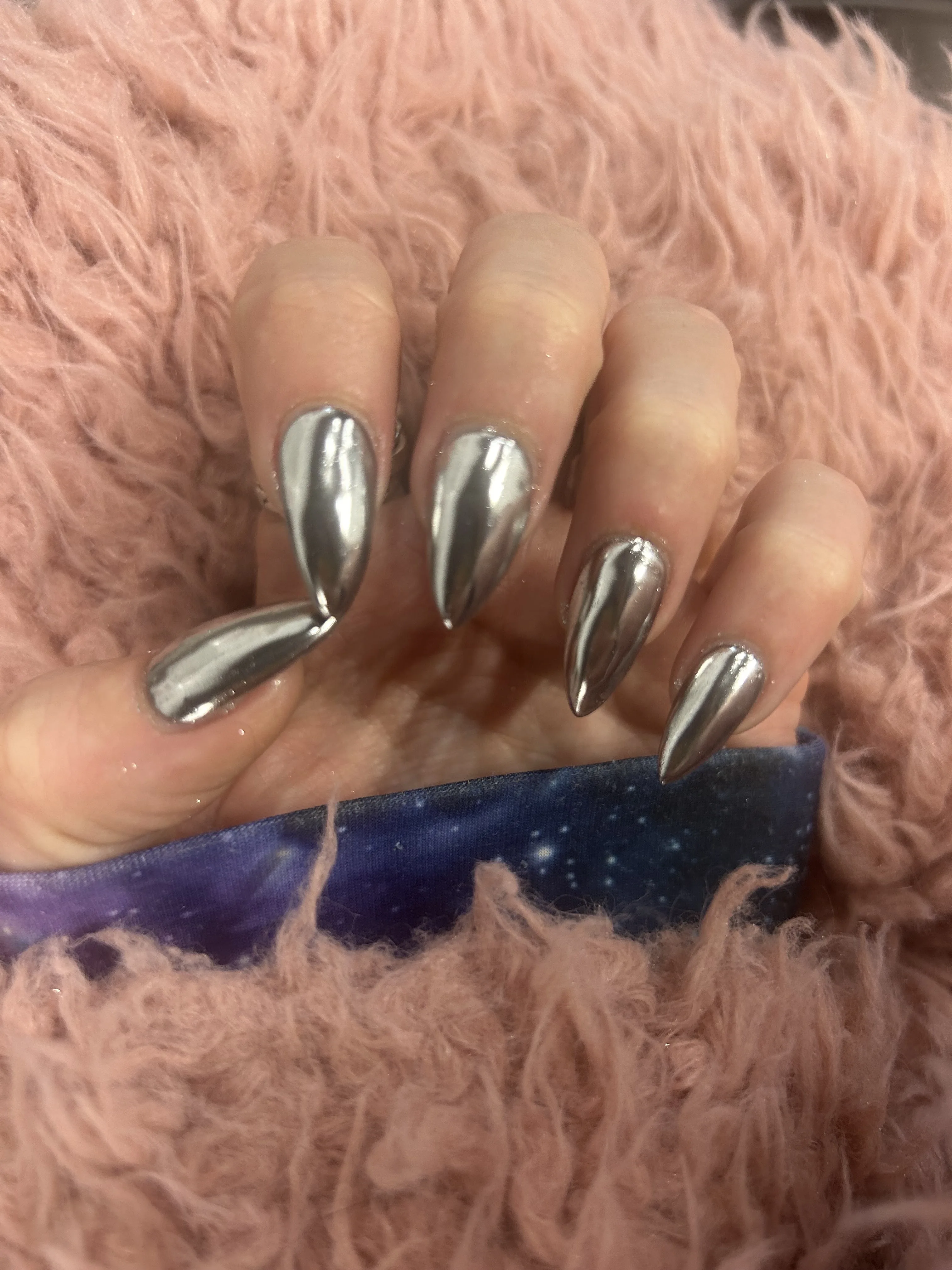 Silver chrome stiletto nails on pink faux fur — Minack Beauty nail work